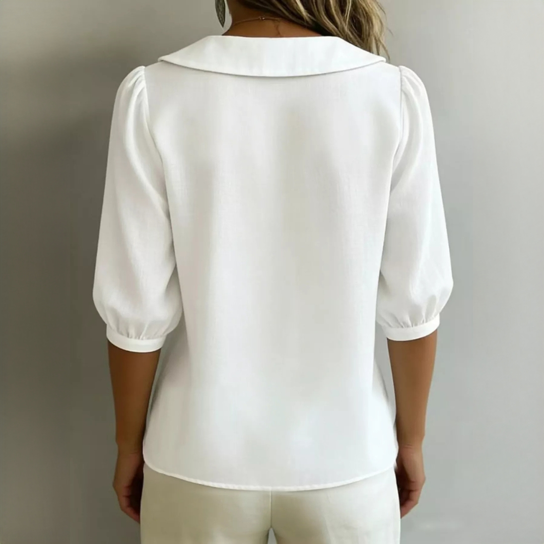 Blusa feminina com gola Peter Pan e fechamento frontal por botões - mangas bufantes 3/4, caimento relaxado