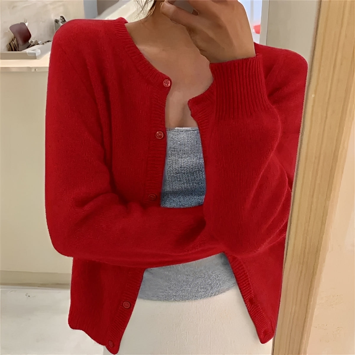 Cardigan feminino com fechamento de botões, punhos canelados e corte regular