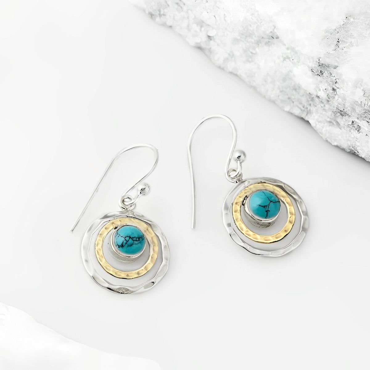Nayah – Brincos Boho Saturno com pedra turquesa, acabamento em prata e ouro