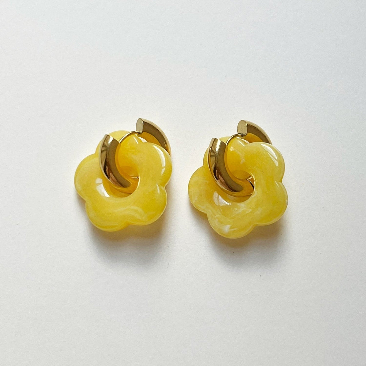 Anéis de donut amarelos com pendente de flor